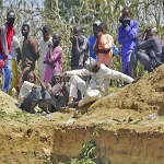 Dozens of people gathered around a mass grave where some of the people who lost their lives in the explosion were buried.