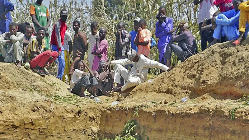 Dozens of people gathered around a mass grave where some of the people who lost their lives in the explosion were buried.