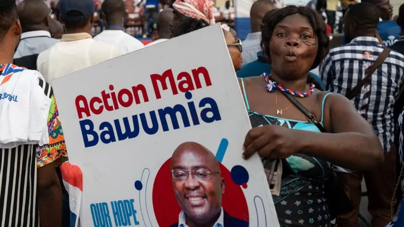 An NPP party supporter with a Bawumia placard with the inscription "Action Man Bawumia".