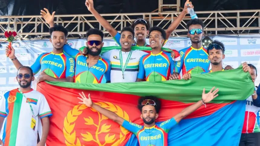 The Eritrean cycling team posing with their nation's flag in a group photo.