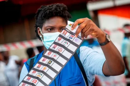 A Ghanaian Electoral Commission official inspecting the 2020 presidential election ballot paper