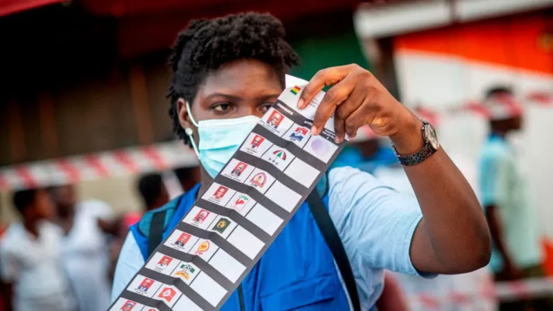 A Ghanaian Electoral Commission official inspecting the 2020 presidential election ballot paper