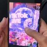 A mobile phone's screen displaying TikTok live and the app's logo.