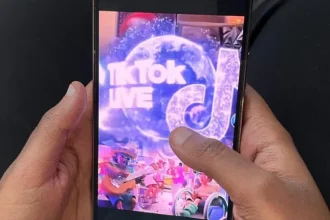 A mobile phone's screen displaying TikTok live and the app's logo.