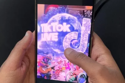 A mobile phone's screen displaying TikTok live and the app's logo.